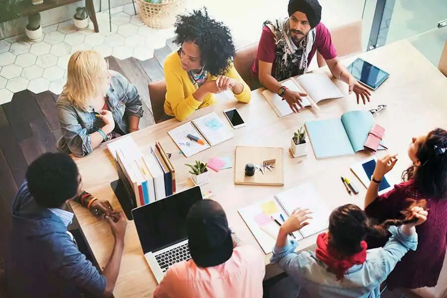Overhead view of a diverse team collaborating around a meeting table