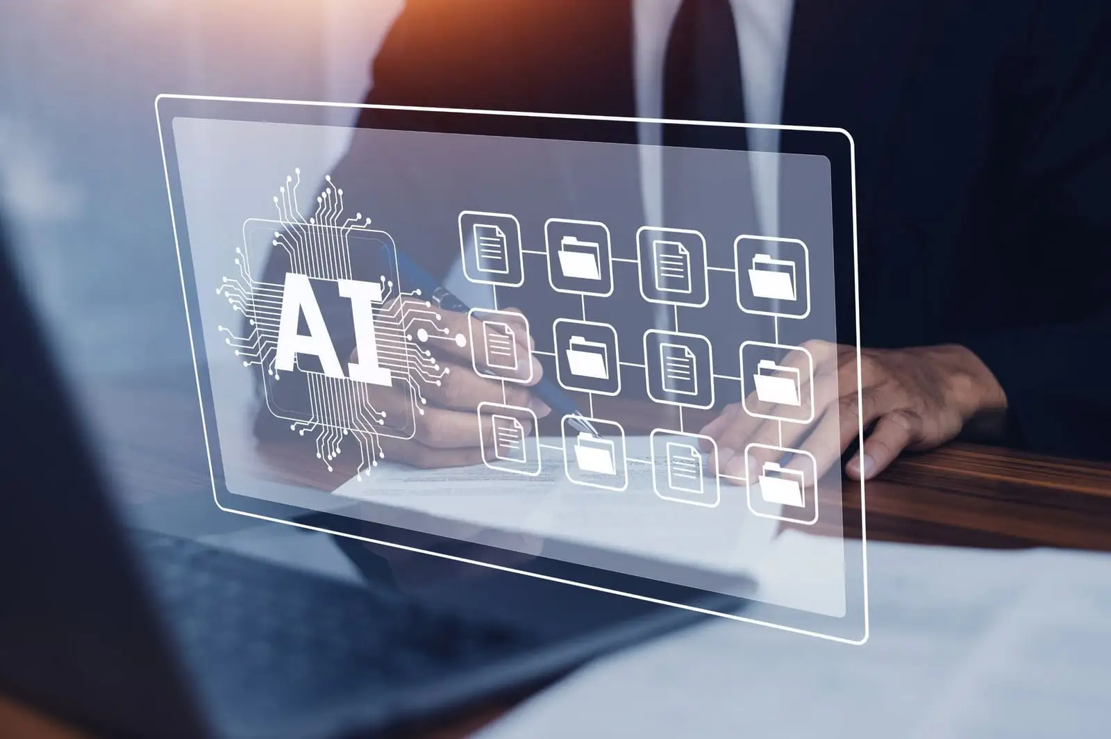 AI icon overlaying linked document and folder icons above a businessperson's hands at a laptop
