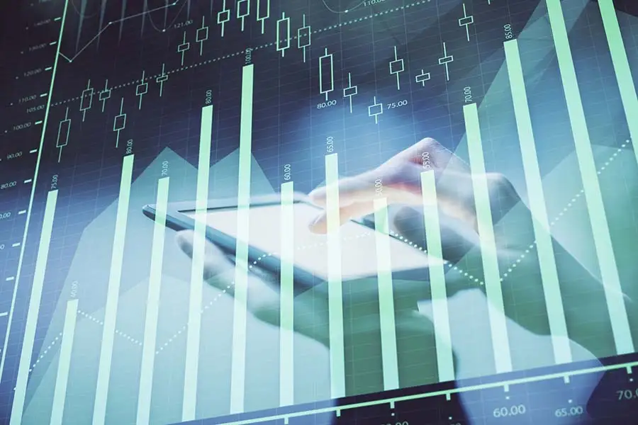 Hand holding a smartphone overlaid with spend analytics bar charts and trend lines