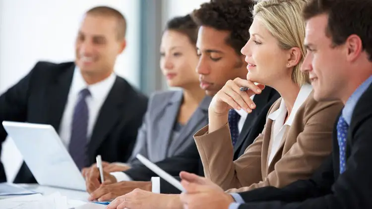 A procurement team reviewing an RFP document together at a table