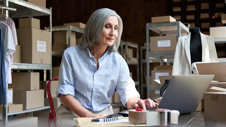 A procurement manager and a supplier review performance metrics together