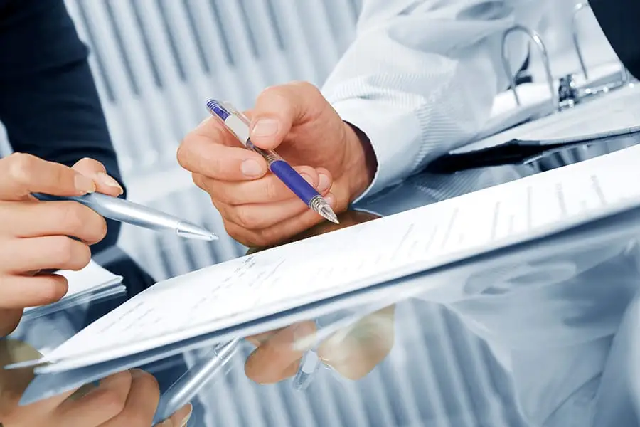 Procurement team reviewing a signed contract document